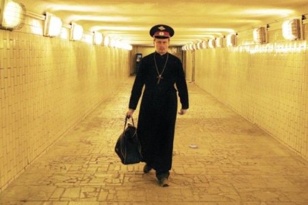 Voina - A Cop in a Priest's Robe"? Oleg: It's an absurd image of a cop wearing a priest's robe and enjoying total impunity. In the action, I took five large bags of food in the supermarket, went through the counter without paying, passed security and left. I met no challenge. A cop in the priest's robe is like Satan – he could do anything he likes.