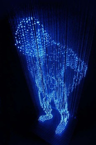 Man with No Shadows by Makoto Tojiki: Consruction of a life-sized man made of LED lights which hang on threads from the ceiling.